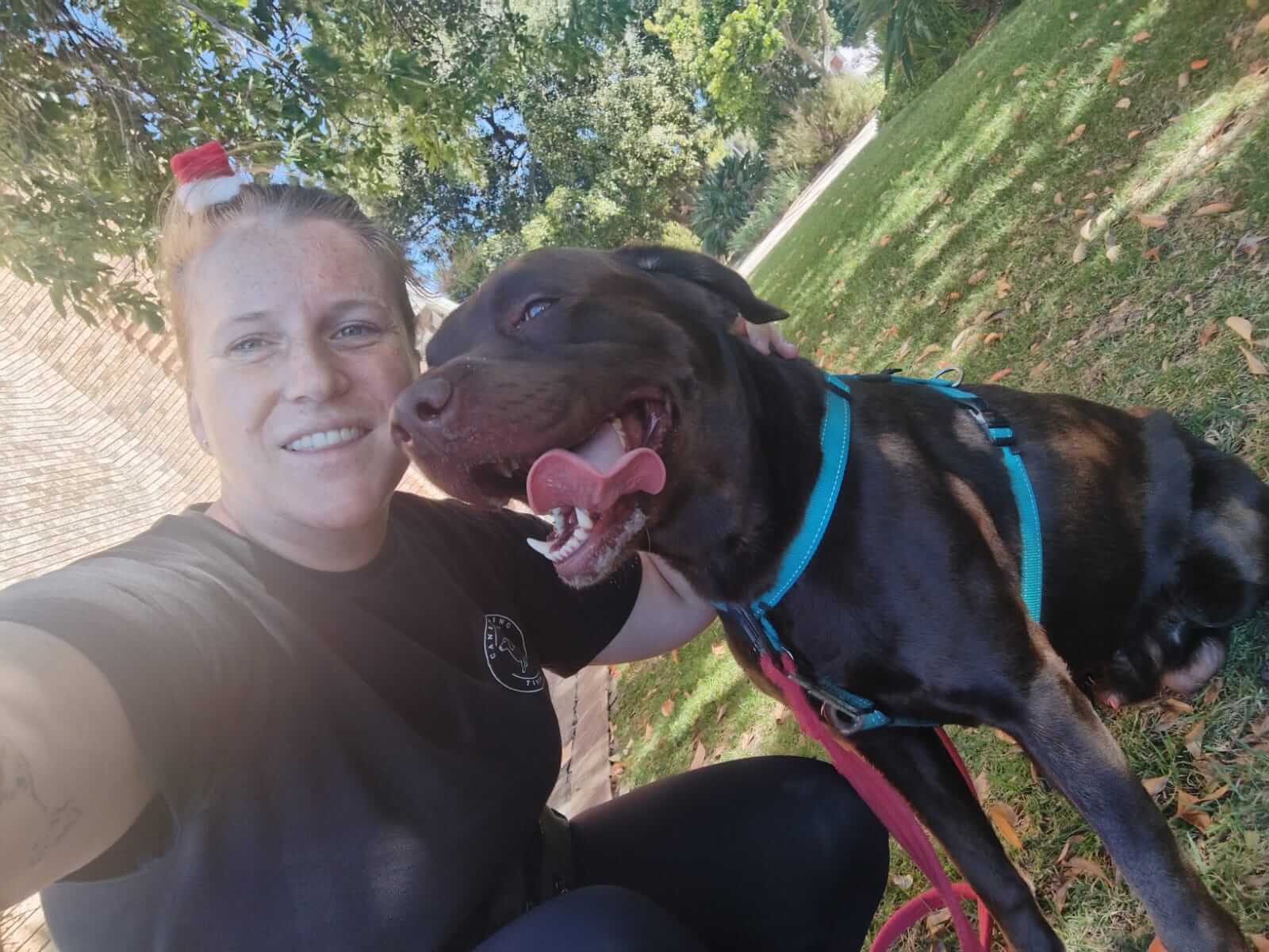 Charlean sharing a nose-to-nose moment with a dog in a golden field